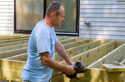 carpenter-hammering-installing-wooden-deck-patio_73110-3377